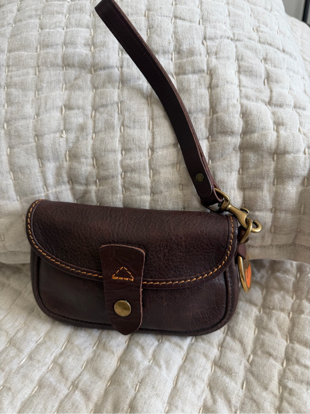 Dooney&Bourke Vintage Brown Leather Wristlet with Duck tag and strap.